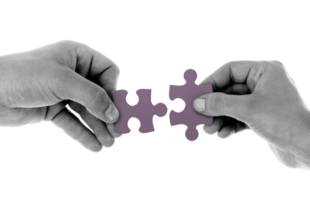 Managing Payroll In A Merger Or Acquisition two people