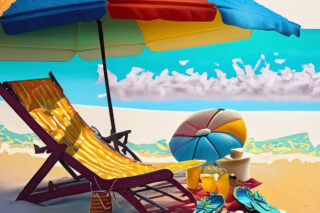 A deck chair on a beach.